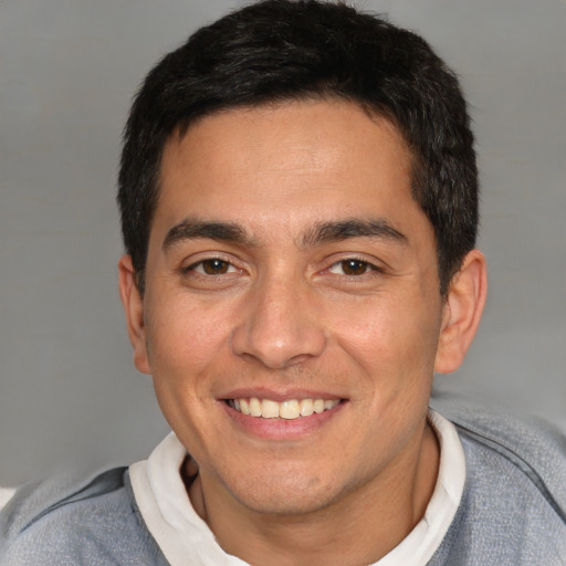 Joyful white young-adult male with short  black hair and brown eyes