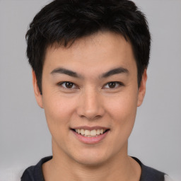 Joyful asian young-adult male with short  black hair and brown eyes