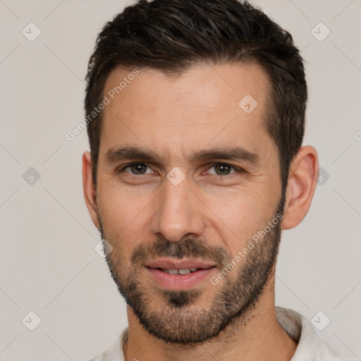 Joyful white young-adult male with short  brown hair and brown eyes