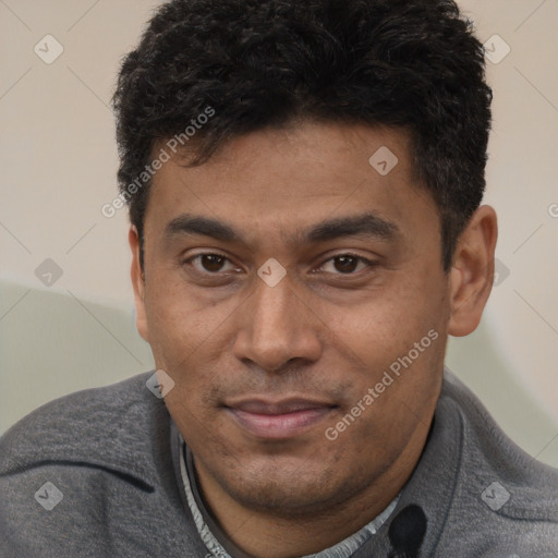 Joyful latino young-adult male with short  brown hair and brown eyes