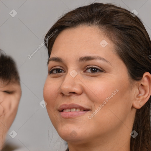 Joyful white adult female with medium  brown hair and brown eyes