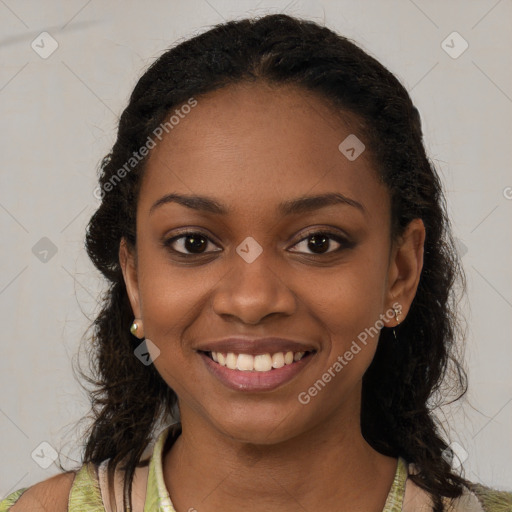 Joyful black young-adult female with long  brown hair and brown eyes