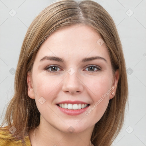 Joyful white young-adult female with long  brown hair and grey eyes