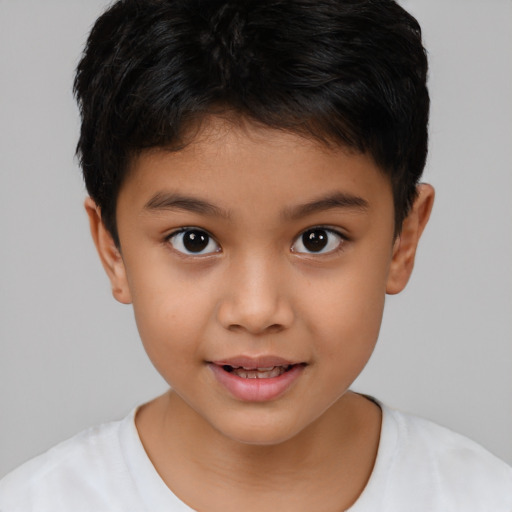 Joyful latino child male with short  brown hair and brown eyes