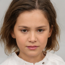 Joyful white child female with medium  brown hair and brown eyes