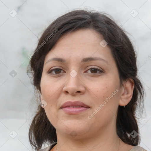 Joyful white adult female with medium  brown hair and brown eyes