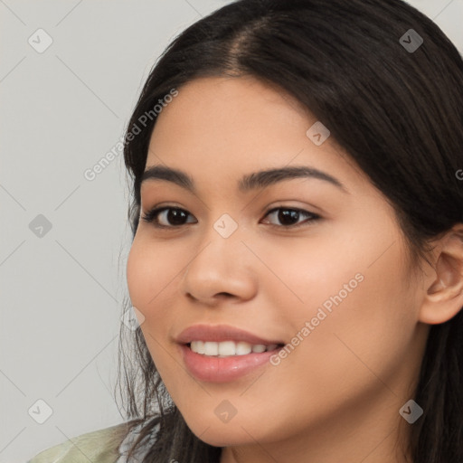 Joyful latino young-adult female with long  brown hair and brown eyes