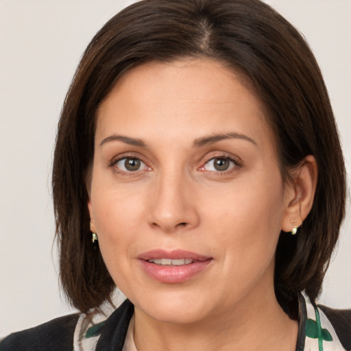 Joyful white adult female with medium  brown hair and brown eyes