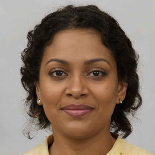 Joyful black young-adult female with medium  brown hair and brown eyes