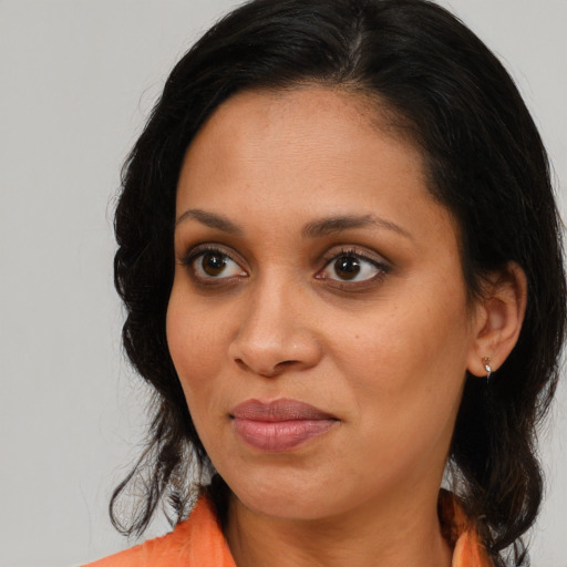 Joyful black young-adult female with medium  brown hair and brown eyes