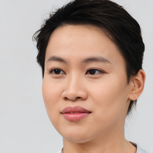 Joyful asian young-adult female with medium  brown hair and brown eyes
