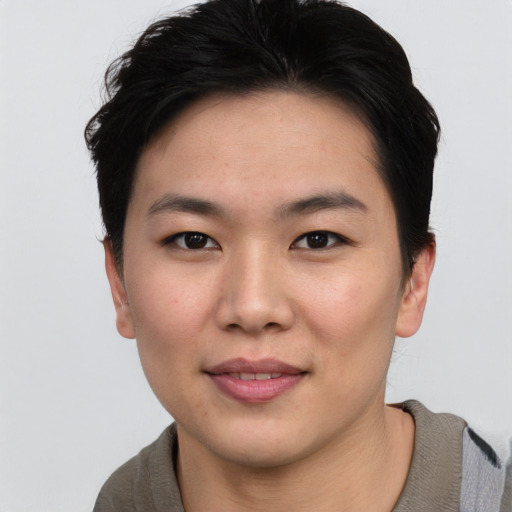 Joyful asian young-adult female with short  black hair and brown eyes