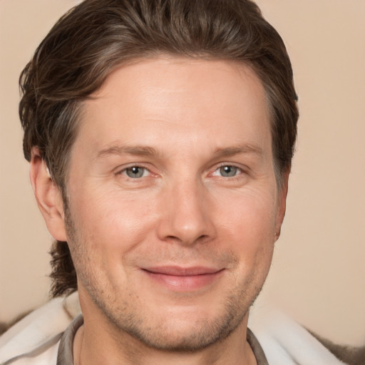 Joyful white adult male with short  brown hair and brown eyes