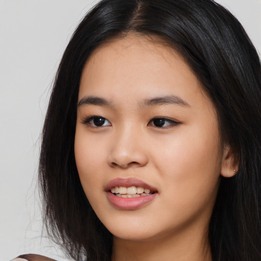 Joyful asian young-adult female with long  black hair and brown eyes