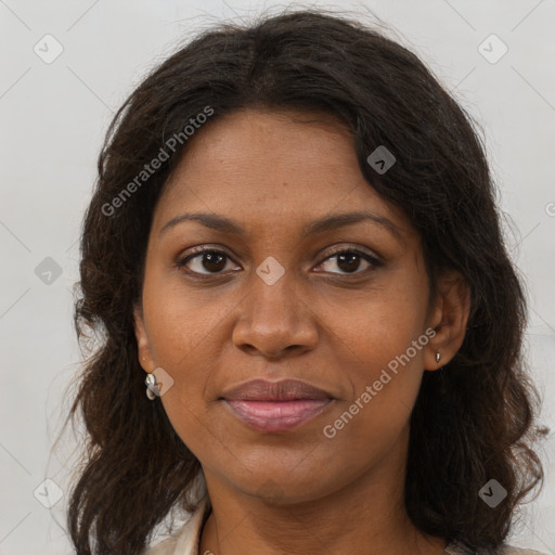 Joyful black adult female with long  brown hair and brown eyes