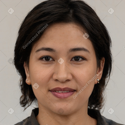 Joyful latino adult female with medium  brown hair and brown eyes