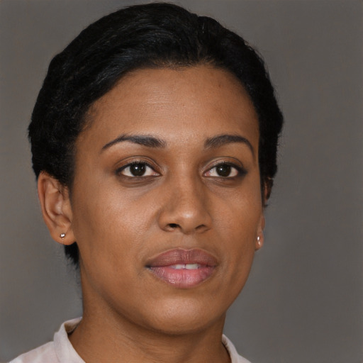 Joyful black young-adult female with short  brown hair and brown eyes