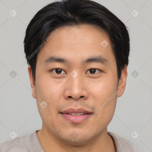 Joyful asian young-adult male with short  brown hair and brown eyes