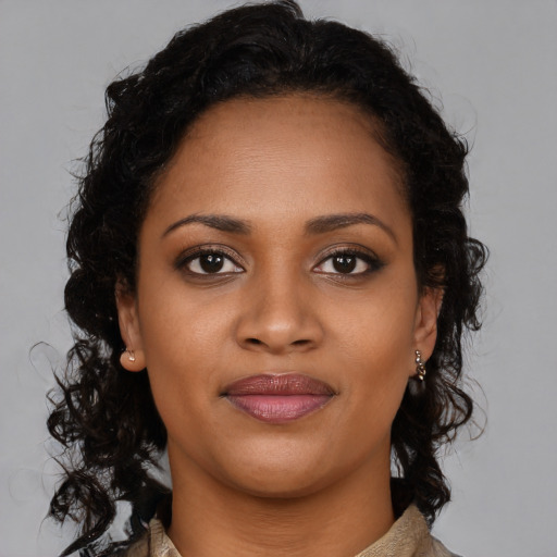 Joyful black young-adult female with medium  brown hair and brown eyes