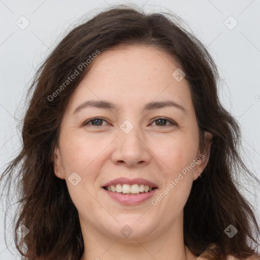 Joyful white adult female with long  brown hair and brown eyes