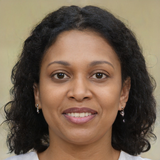 Joyful black young-adult female with medium  brown hair and brown eyes
