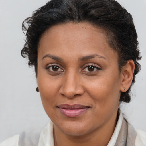 Joyful latino adult female with short  brown hair and brown eyes