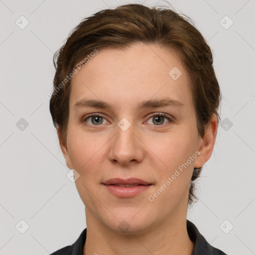 Joyful white young-adult female with short  brown hair and grey eyes