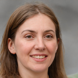 Joyful white young-adult female with long  brown hair and grey eyes