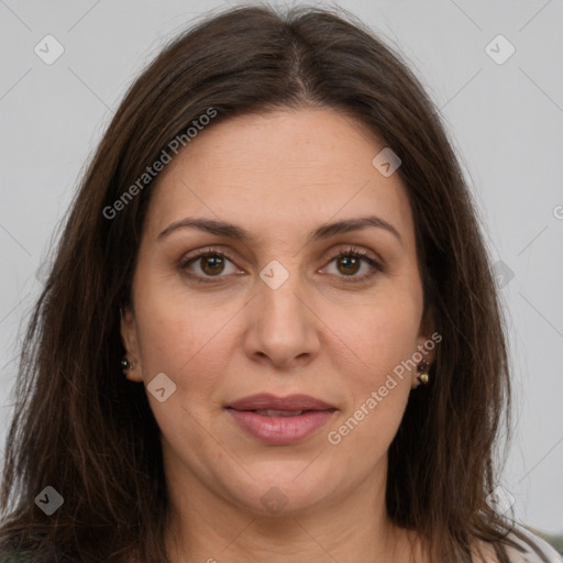 Joyful white adult female with long  brown hair and brown eyes