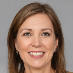 Joyful white adult female with medium  brown hair and grey eyes