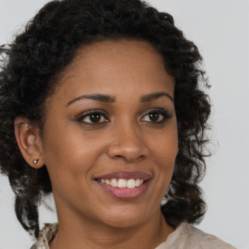 Joyful black young-adult female with medium  brown hair and brown eyes