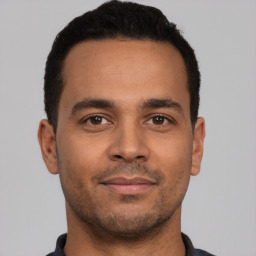 Neutral latino young-adult male with short  brown hair and brown eyes