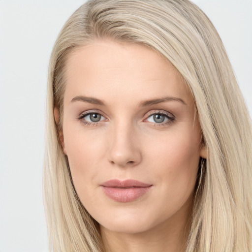 Joyful white young-adult female with long  brown hair and blue eyes