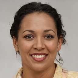 Joyful latino young-adult female with medium  brown hair and brown eyes