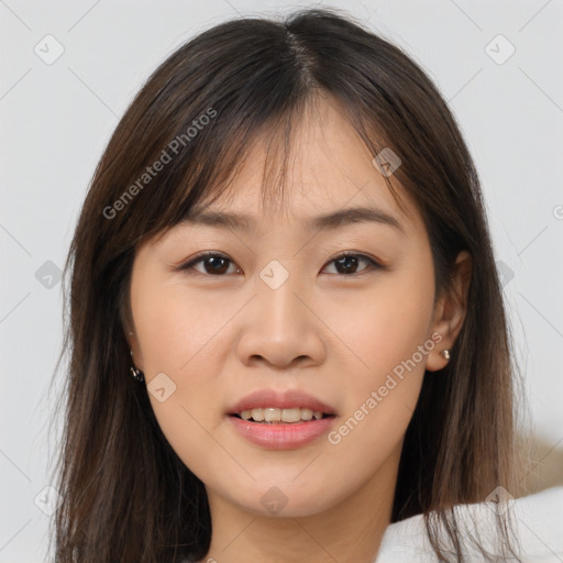 Joyful asian young-adult female with long  brown hair and brown eyes