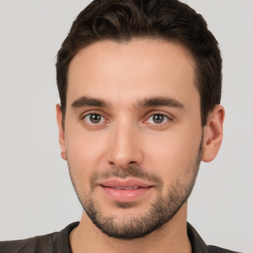 Joyful white young-adult male with short  brown hair and brown eyes