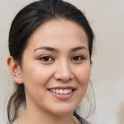 Joyful white young-adult female with medium  brown hair and brown eyes