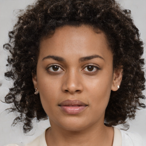 Neutral black young-adult female with medium  brown hair and brown eyes