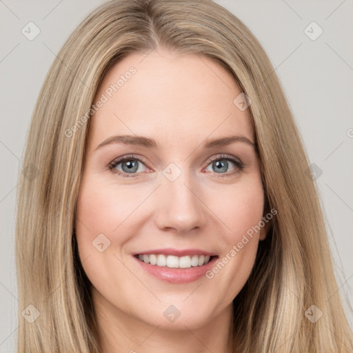 Joyful white young-adult female with long  brown hair and grey eyes