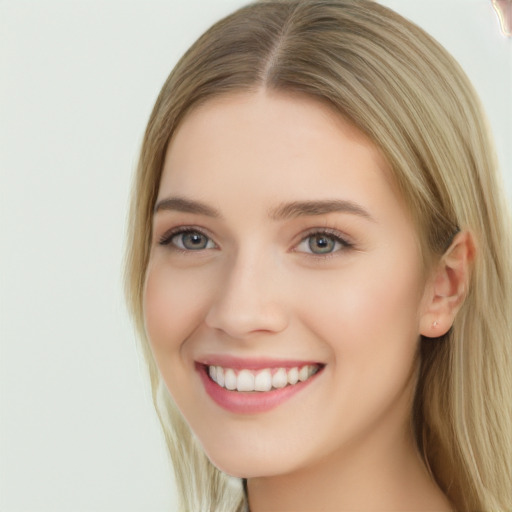 Joyful white young-adult female with long  brown hair and green eyes