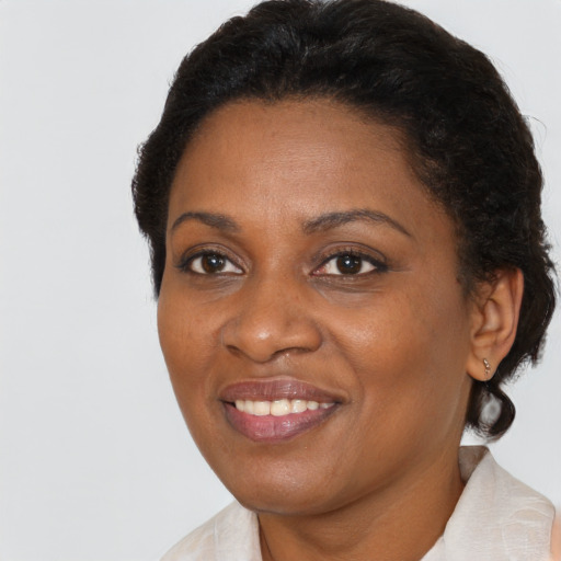 Joyful black adult female with short  brown hair and brown eyes