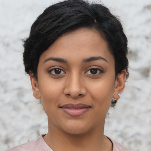 Joyful latino young-adult female with short  black hair and brown eyes