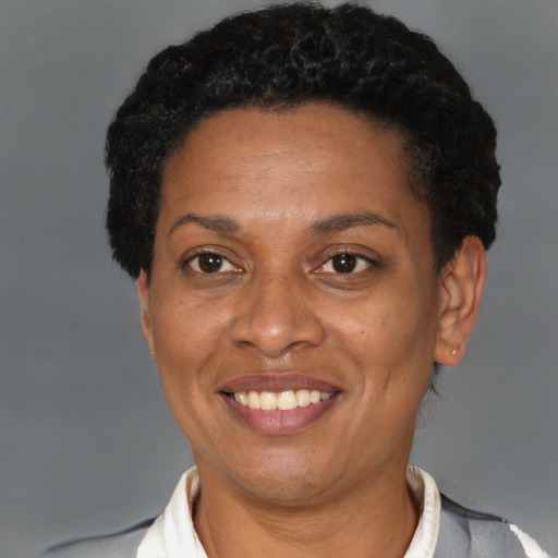 Joyful black adult female with short  brown hair and brown eyes