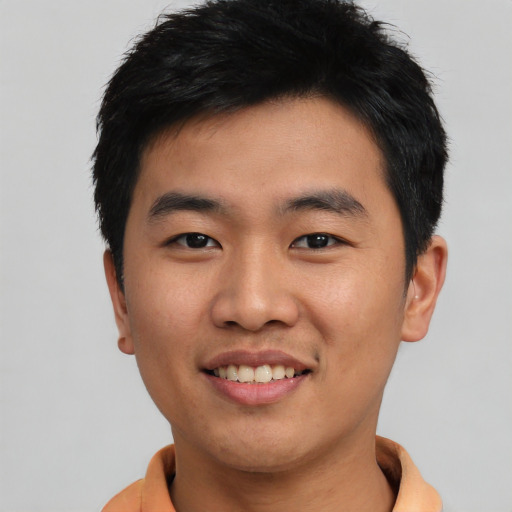 Joyful asian young-adult male with short  black hair and brown eyes