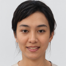 Joyful asian young-adult female with medium  black hair and brown eyes