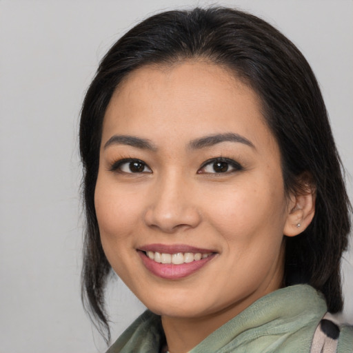 Joyful asian young-adult female with medium  brown hair and brown eyes