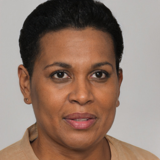 Joyful black adult female with short  brown hair and brown eyes