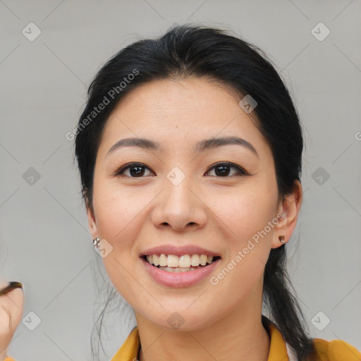 Joyful asian young-adult female with medium  brown hair and brown eyes