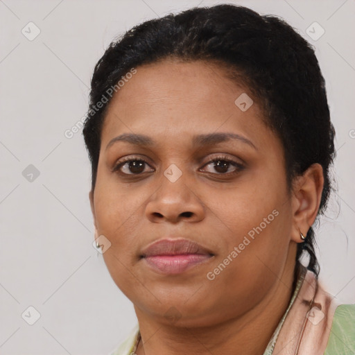 Joyful black adult female with short  brown hair and brown eyes