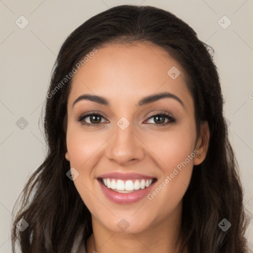 Joyful latino young-adult female with long  brown hair and brown eyes